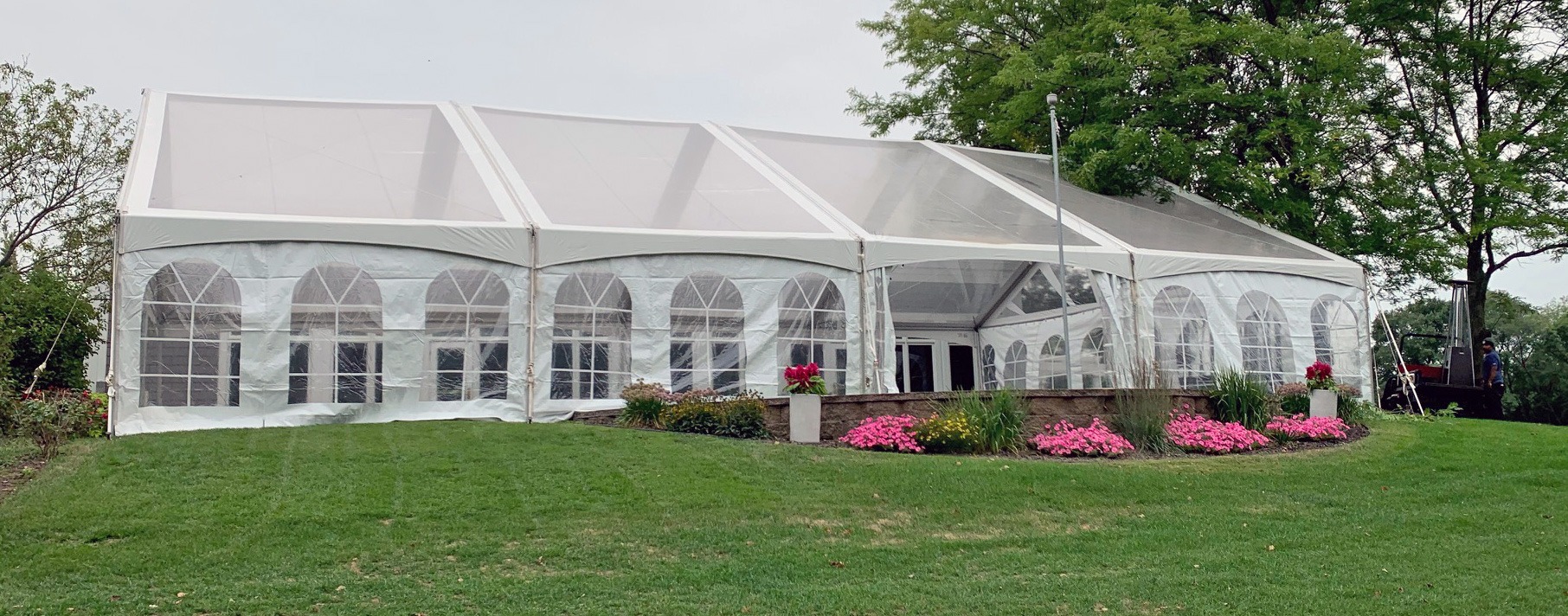 A 80'x40' clear top X2 frame tent with gable sunburst ends with french window siding from Lefty's Tent & Party Rental in Bovey, MN.